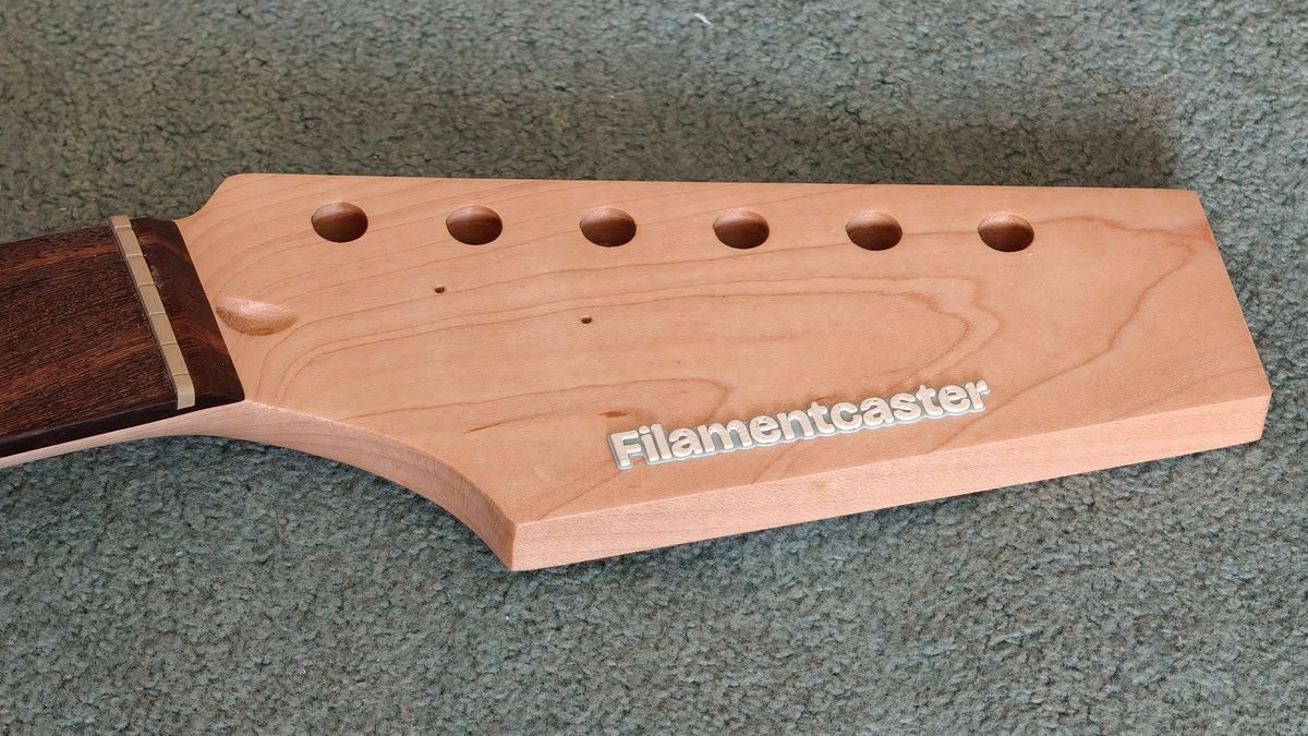 The Filamentcaster logo on the headstock.